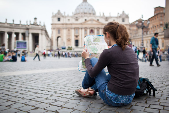 pretty-young-female-tourist-studying-a-map-at-st-peters-square